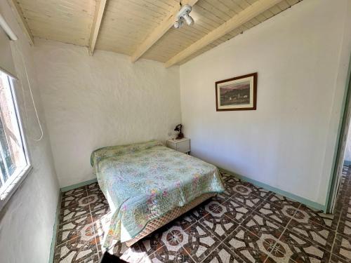 a bedroom with a bed in the corner of a room at Casa Río General Belgrano in General Belgrano