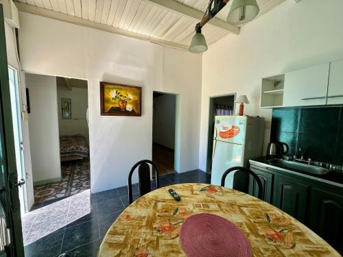 a kitchen with a table and a refrigerator at Casa Río General Belgrano in General Belgrano