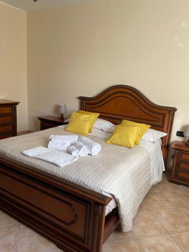 a bed with two towels and two pillows on it at RoMi's house in Colonna
