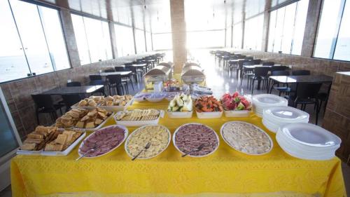 a table filled with different types of food on at Pousada Vela Mar in Maragogi