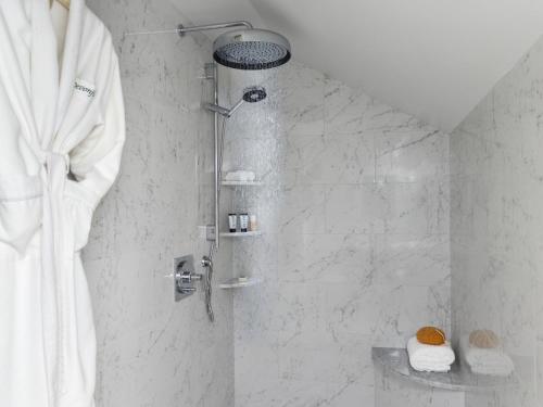 a shower in a bathroom with a shower curtain at Devonfield Inn in Lee