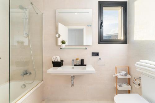 a bathroom with a sink and a shower and a mirror at Luxury penthouse with ocean views in Estepona