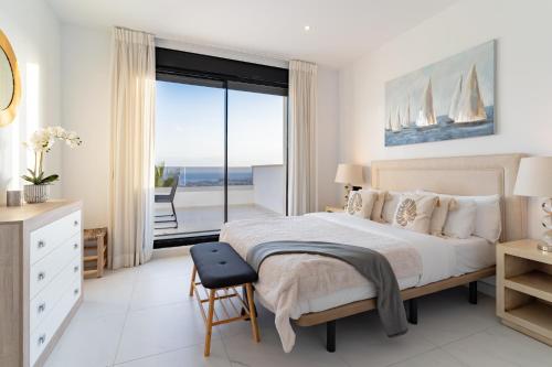 a bedroom with a bed and a view of the ocean at Luxury penthouse with ocean views in Estepona