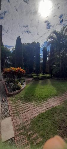 a garden with flowers and trees in a park at Quinta Isabel in Ibagué