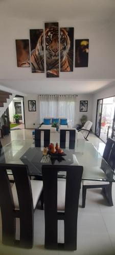 a living room with a glass table and chairs at Quinta Isabel in Ibagué