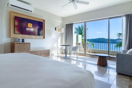 a hotel room with a bed and a large window at Camino Real Acapulco Diamante in Acapulco