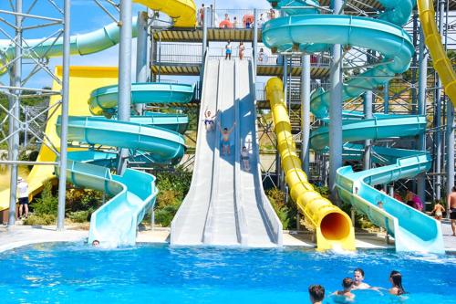 a water slide at a water park with people in the water at Olive Tree in Tirana
