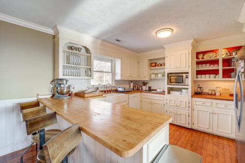 a kitchen with white cabinets and a wooden counter top at 5 Mi to Dtwn Pet-Friendly Gem in Blowing Rock! in Blowing Rock