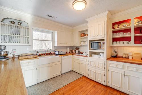 a white kitchen with white cabinets and a window at 5 Mi to Dtwn Pet-Friendly Gem in Blowing Rock! in Blowing Rock