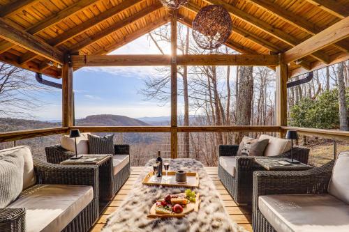 a screened in porch with couches and a table at 5 Mi to Dtwn Pet-Friendly Gem in Blowing Rock! in Blowing Rock
