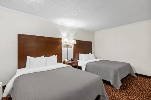 a hotel room with two beds and two lamps at Quality Inn Marietta near Dobbins ARB in Marietta