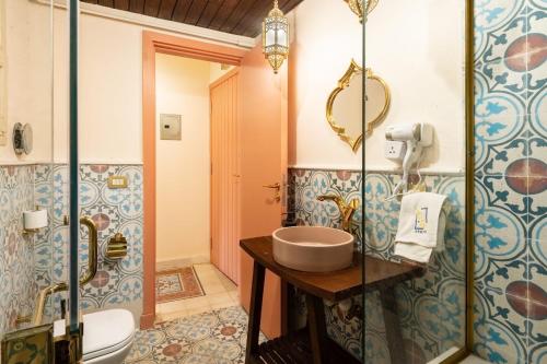 a bathroom with a sink and a toilet at The Majestic Marrakesh Studio Cairo's Downtown 19A in Cairo