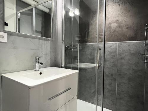 une salle de bain avec un lavabo et une douche en verre dans l'établissement Résidence Le Tourmalet - maeva Home - Appartement 2 pièces 6 personnes - Sélection MAE-0421, à La Mongie