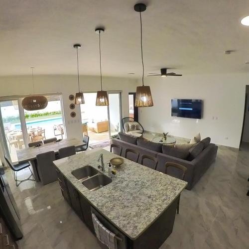 a kitchen and living room with a couch and a table at Villa Ruby Bella in Sosúa