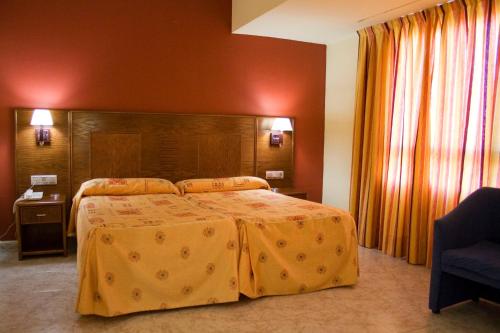 Postel nebo postele na pokoji v ubytování Hotel Perales