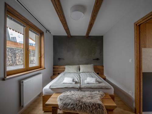 a bedroom with a bed and a window at Apartment Lana in Kranjska Gora