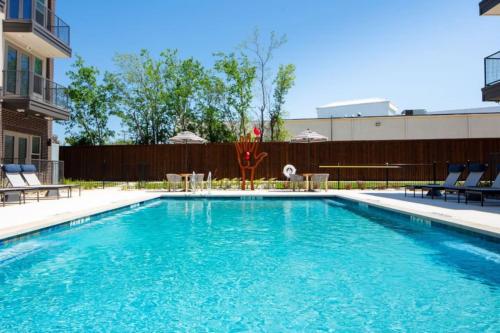 a swimming pool with blue water in a building at Serene Retreat Pool 2 Min to TCU in Fort Worth