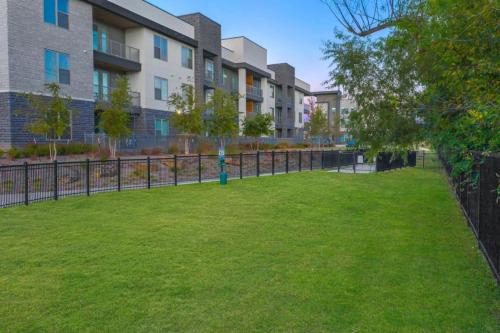 a park in front of a building with a fence at Charming 2BD 2BA with Beautiful Pool in in Fort Worth