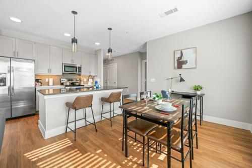 a kitchen with a table and chairs and a kitchen with white cabinets at Charming 2BD 2BA with Beautiful Pool in in Fort Worth