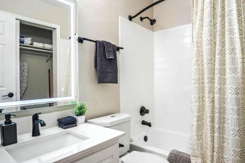 a white bathroom with a sink and a mirror at Contemporary 1BR 1Bat Pool Access in Austin