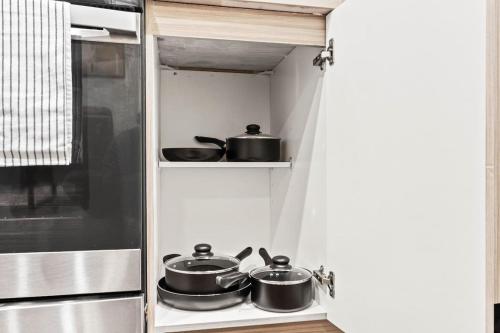 a kitchen with pots and pans sitting on a stove at Luxurious New Unit 1Bd1Ba Pool, Golf Sim in Austin