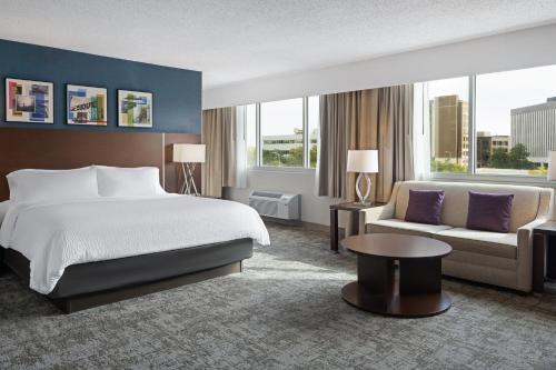 a hotel room with a bed and a couch at Holiday Inn Sioux Falls-City Center by IHG in Sioux Falls