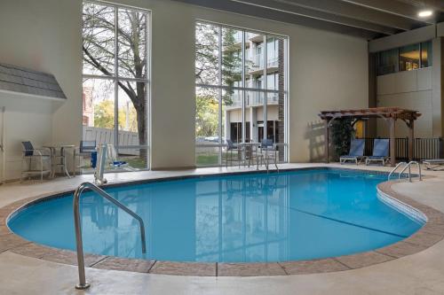 a large pool with blue water in a building at Holiday Inn Sioux Falls-City Center by IHG in Sioux Falls