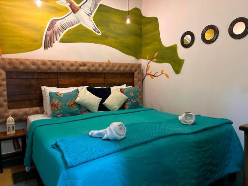 a bedroom with a bed with two baby towels on it at Hotel Boutique Stay La 10 in Medellín