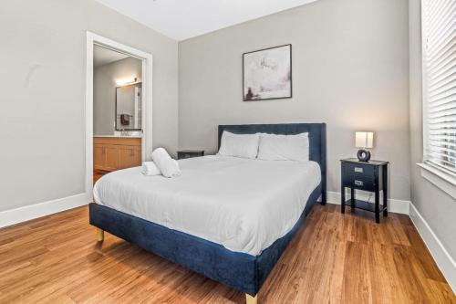 a bedroom with a large bed and a wooden floor at Fascinating 2BD 2BA w Beautiful Pool in Fort Worth in Fort Worth