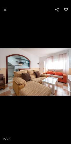 a living room with a couch and a table at Casa Ana in Punta Umbría