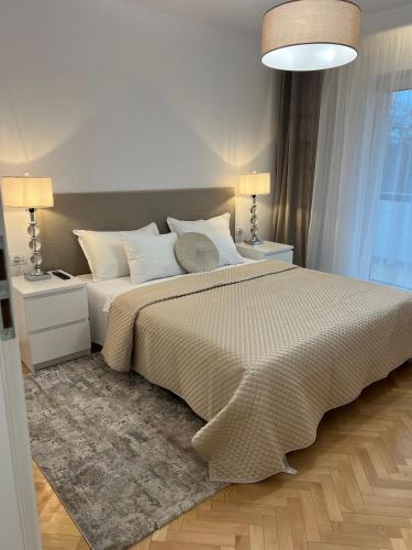 a bedroom with a large bed with two night stands at Atmosfera Sibiu in Sibiu