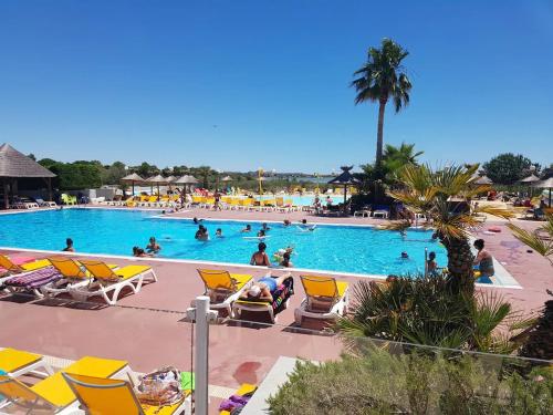 a pool at a resort with people swimming in it at Cb - Espace & confort, 3 ch, 41m2, proche mer in Lattes