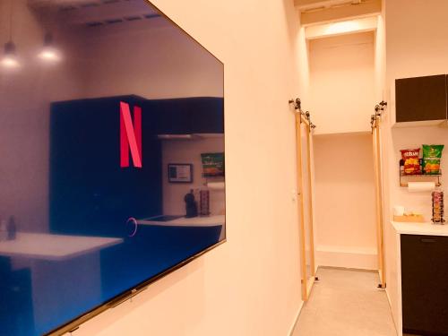 a mirror on a wall with a n on it at Gook Home CENTER in Jerez de la Frontera