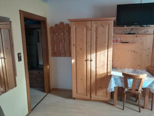 a room with a table and a cabinet and a television at Haus Wastl in Seebach