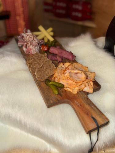 a wooden plate with food on top of a table at Nash Pratik Hotel in Geneva