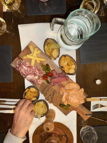 a table with a cutting board with food on it at Nash Pratik Hotel in Geneva