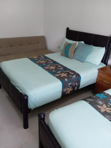 two beds sitting next to each other in a room at Casa las Flores in Puerto Vallarta