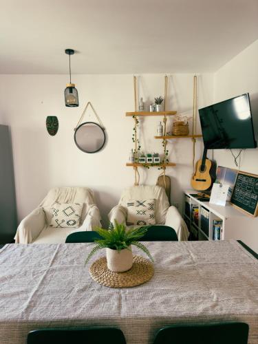 a living room with a table and two chairs at Surf&Sleep in Corralejo