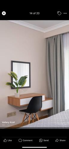 a bedroom with a desk and a chair and a plant at Jlynn retreat -2 Bed Rooms Apartment in Dar es Salaam