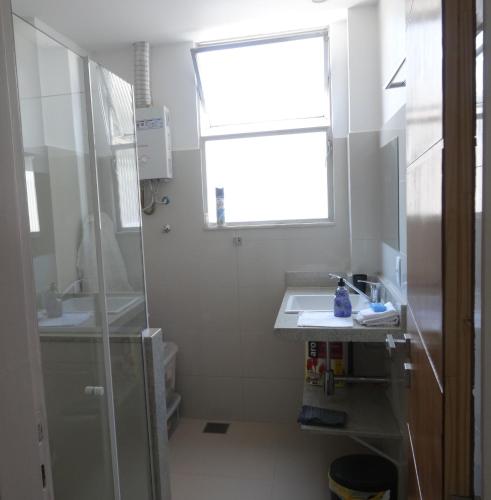 a small bathroom with a sink and a window at Copacabana wonderful apartment in Rio de Janeiro