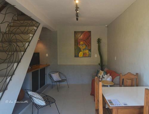 a living room with a staircase and a table and chairs at Pousada Serra Grisante in Lençóis