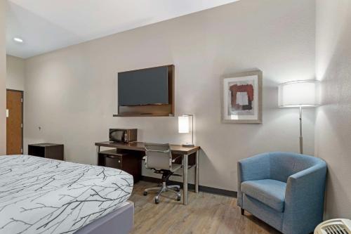 a hotel room with a bed and a desk and a tv at Best Western Casino Inn in Vinton