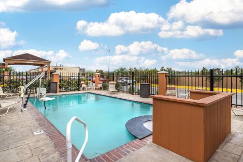 a swimming pool at a resort with a fence at Best Western Casino Inn in Vinton