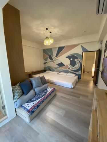 a room with a couch and a bed in it at Lounge away in Taitung City