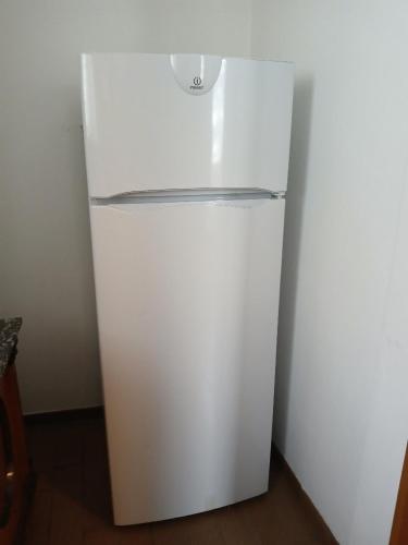 a white refrigerator sitting in a room with at Haus Taxberg in Taxenbach