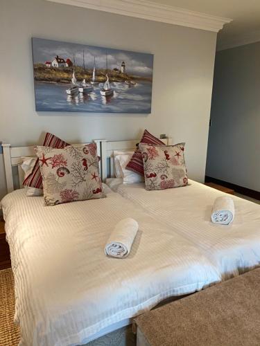 a bedroom with two beds with towels on them at Villa on the Bay in Stompneusbaai