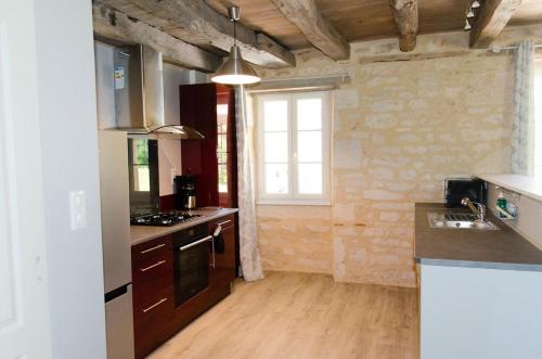 a kitchen with a sink and a stove top oven at Les Gîtes du Villajou in Lachapelle-Auzac