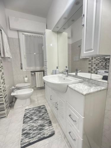 a white bathroom with two sinks and a toilet at Lena Apartment Your Venice Gateway in Mestre in Mestre