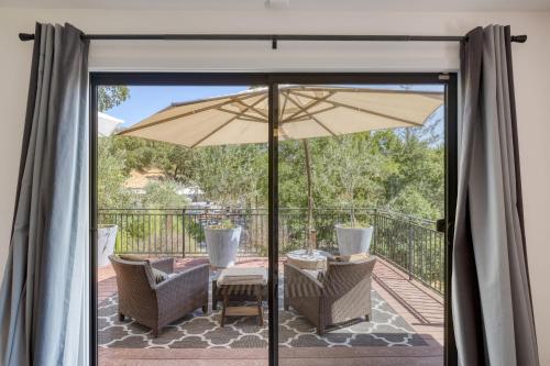 a patio with a table and an umbrella at Kenwood Vista by AvantStay 7acres w Pool Fire Pit Vineyard Views in Kenwood