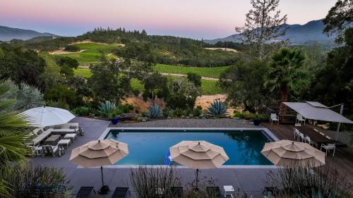 a view of a pool with umbrellas at Kenwood Vista by AvantStay 7acres w Pool Fire Pit Vineyard Views in Kenwood